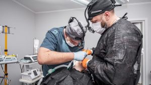 Two surgeons focus on a delicate operation in a Kyiv hospital operating room.